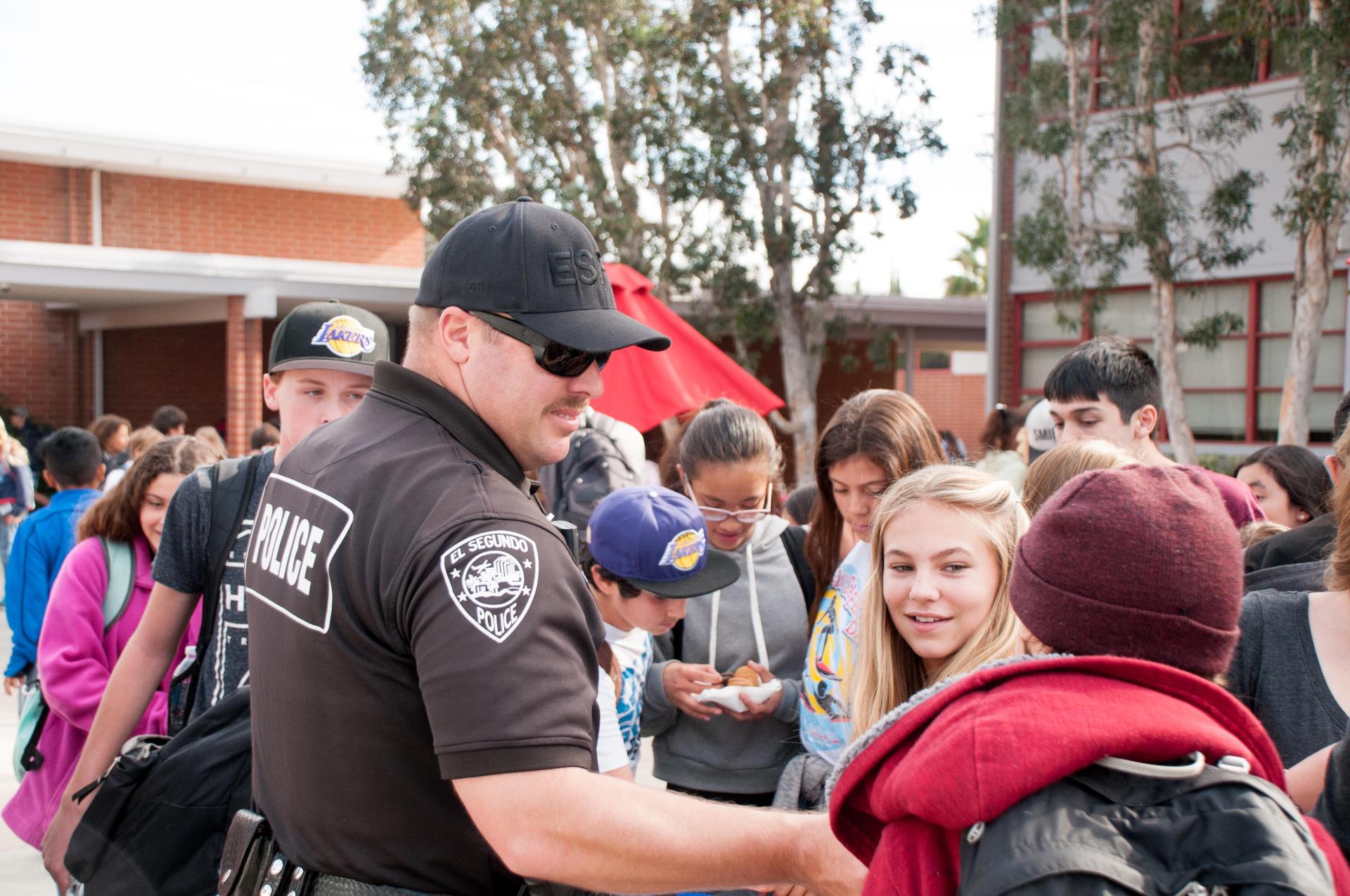ESPD police officer answering questions from smiling teens
